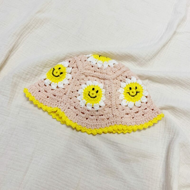 Smiley crochet hat in pink and yellow 